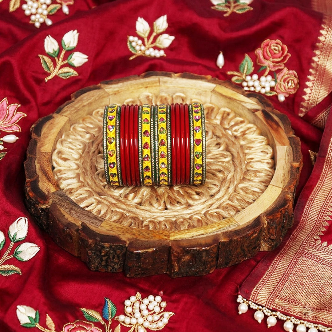 Handmade traditional Rajasthani lac bangles for women in red, green, and yellow with multicolor heart-shaped artificial stones, perfect for bridal wear, weddings, Teej, Sawan, and Karwa Chauth.