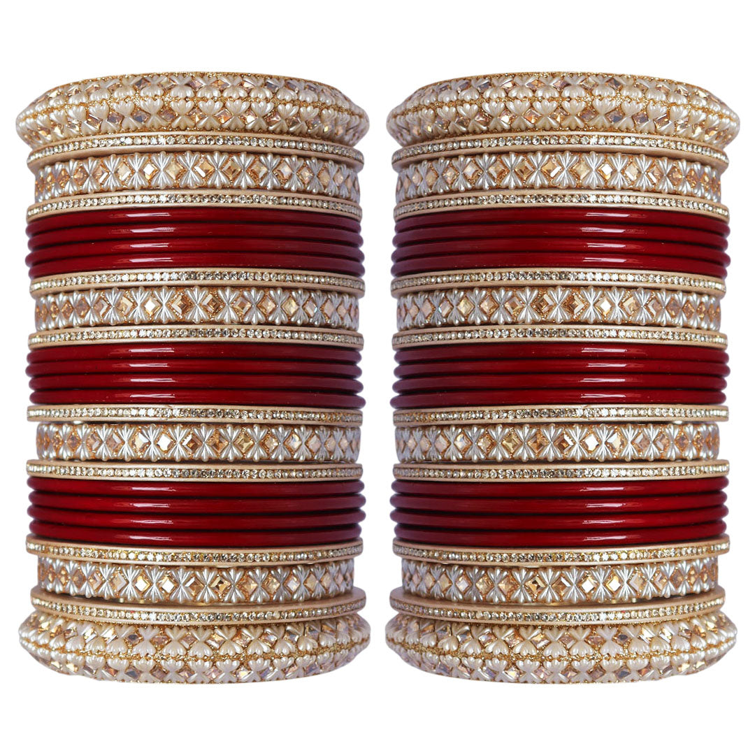 Punjabi-style bridal bangles with ivory-toned decorative patterns and gold-tone embellishments.
