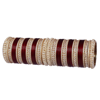 Traditional Punjabi bridal chooda with maroon and red bangles and intricate Kundan-style design.