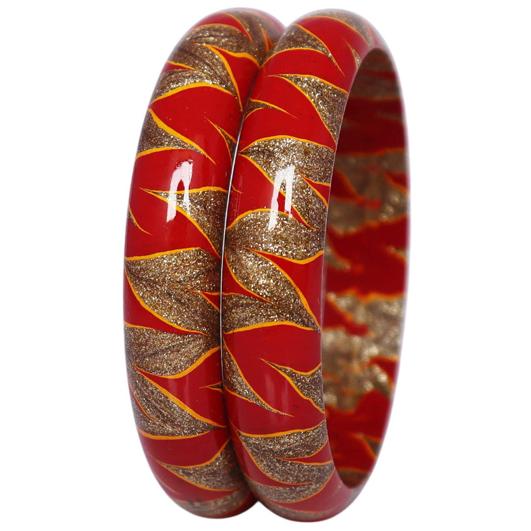 Designer lac bangles set with red and golden swirl pattern